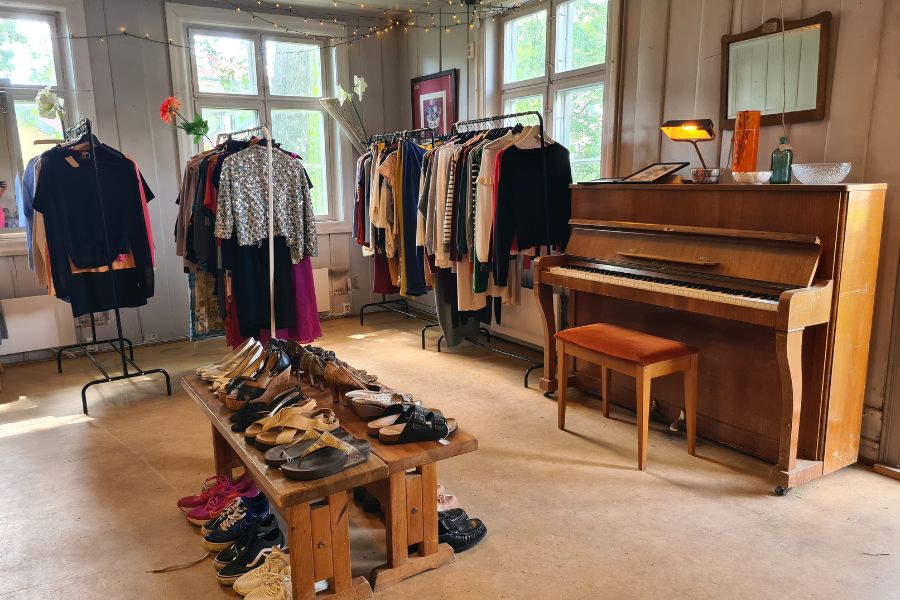Lokalene til Hidden Gem med piano og stativer med klær