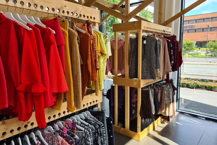 Fargerike klær på stativer hos Bærekraftig Gjenbruk Ulven