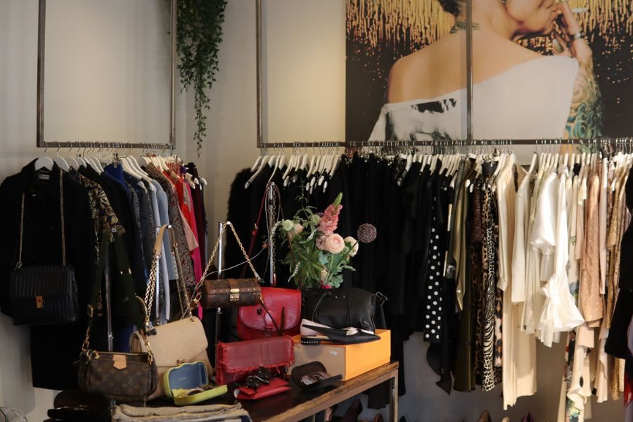 Secondhand og vintage vesker på bord med klesstativ langs veggene hos MA Vintage på Frogner